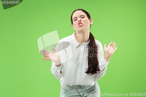 Image of The squint eyed woman with weird expression isolated on green