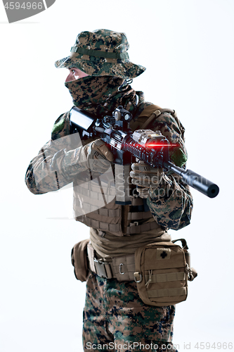 Image of soldier in action aiming laseer sight optics