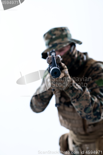 Image of soldier in action aiming laseer sight optics