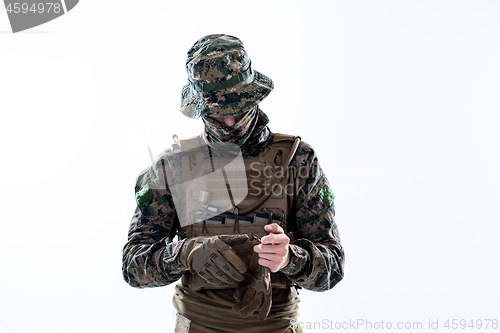 Image of closeup of soldier hands putting protective battle gloves