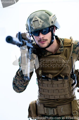 Image of soldier in action aiming laseer sight optics