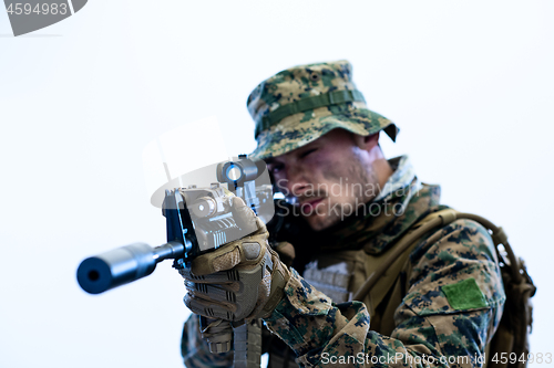 Image of soldier in action aiming laseer sight optics