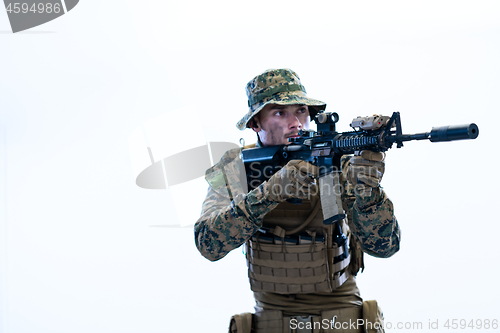 Image of soldier in action aiming laseer sight optics