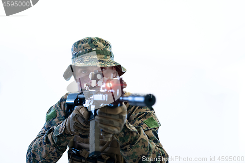 Image of soldier in action aiming laseer sight optics