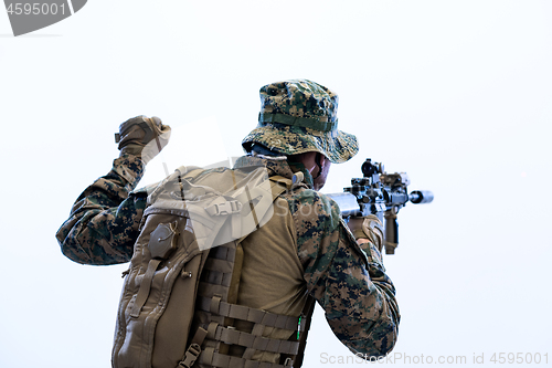 Image of soldier in action giving comands to team by hand sign