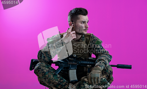 Image of soldier preparing gear for action and checking communication