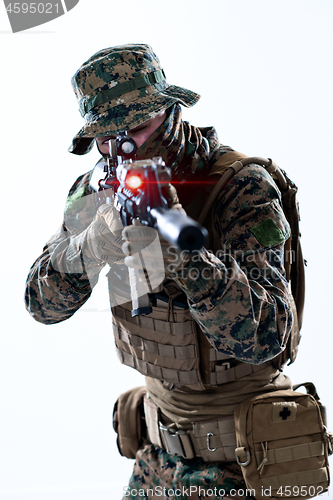 Image of soldier in action aiming laseer sight optics