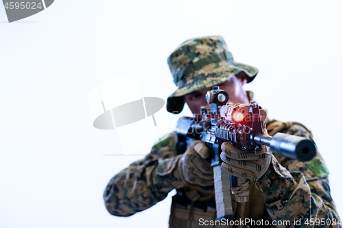 Image of soldier in action aiming laseer sight optics