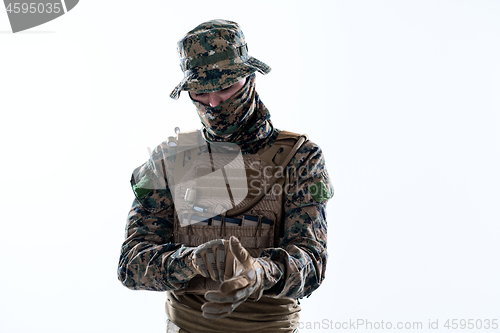 Image of closeup of soldier hands putting protective battle gloves