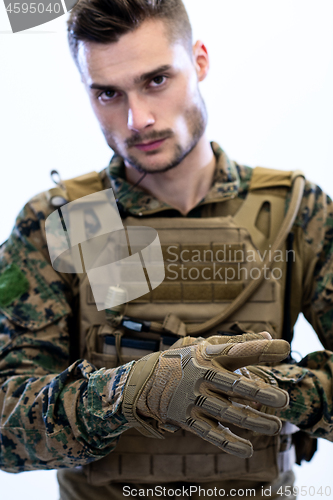 Image of closeup of soldier hands putting protective battle gloves