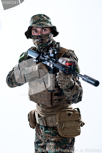 Image of soldier in action aiming laseer sight optics