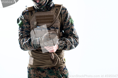 Image of closeup of soldier hands putting protective battle gloves