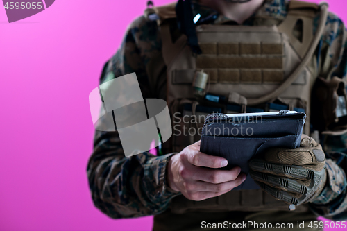Image of soldier using tablet computer closeup