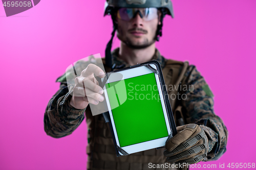 Image of soldier showing a tablet with a blank green screen