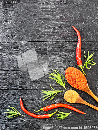 Image of Frame of different pepper and rosemary on black board top