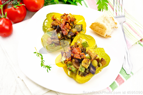 Image of Pepper stuffed with vegetables in plate on white board