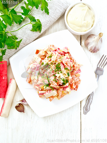 Image of Salad of surimi and tomatoes with mayonnaise on board top