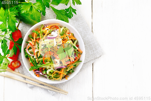 Image of Salad of cucumber in bowl on board top