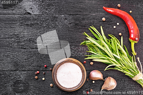 Image of Frame of salt and rosemary on black board top