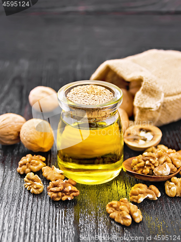 Image of Oil walnut in jar on wooden board