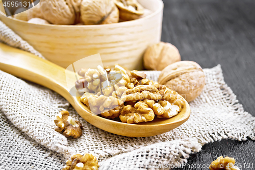 Image of Walnuts in spoon on dark board