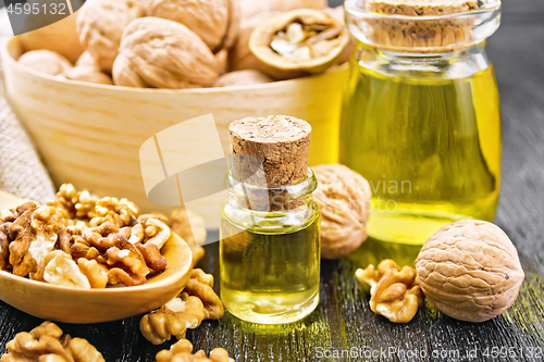 Image of Oil walnut in two jars with spoon on board