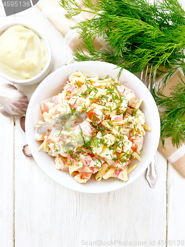 Image of Salad of surimi and eggs with mayonnaise on light board top