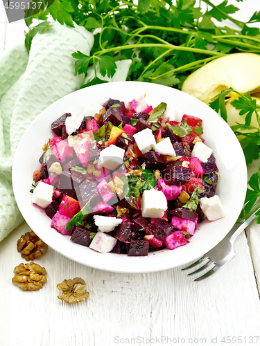 Image of Salad with beetroot and feta in plate on light board