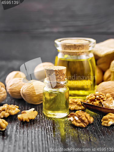 Image of Oil walnut in two jars on wooden board