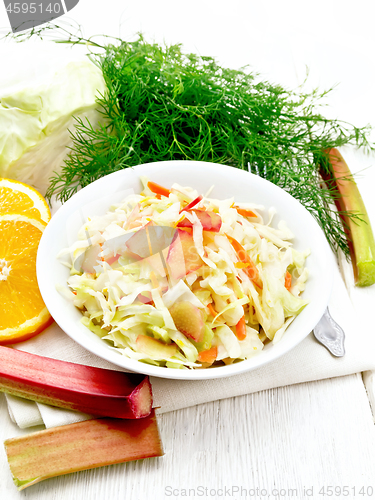 Image of Salad of cabbage and rhubarb in plate on board