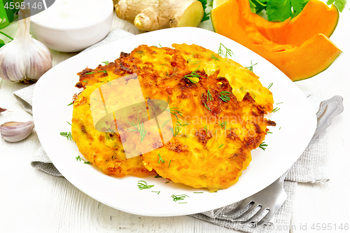 Image of Pancakes of pumpkin in plate on white wooden board