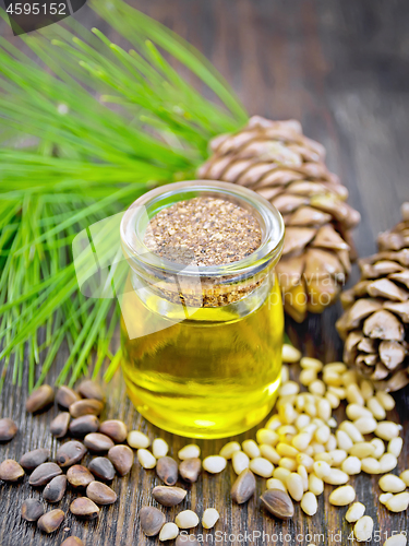 Image of Oil cedar in glass jar on board