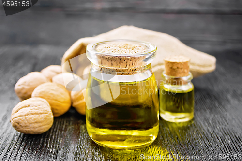 Image of Oil walnut in jar and bottle on board