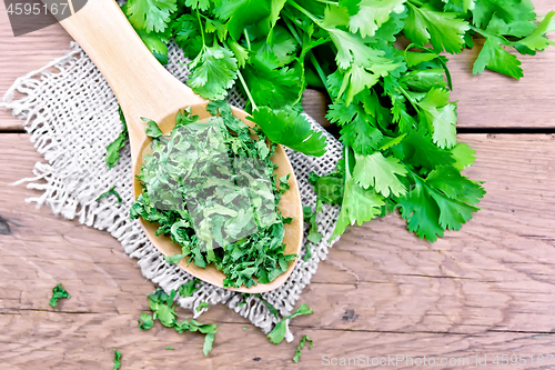 Image of Cilantro dried in spoon on old board top