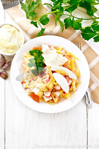 Image of Salad of surimi and tomatoes with eggs on light board top