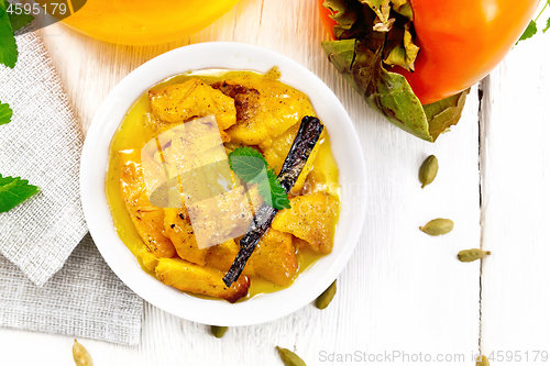 Image of Persimmons baked with honey in dish on board top