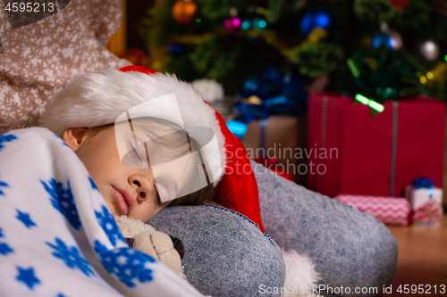 Image of Girl fell asleep on mom\'s lap on New Year\'s Eve, close-up