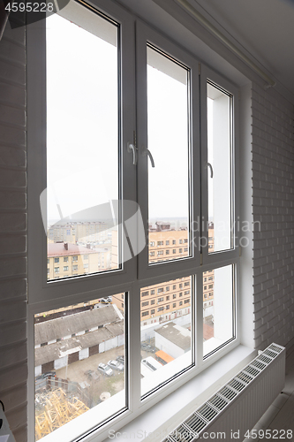 Image of Stained glass high and wide plastic windows in the apartment