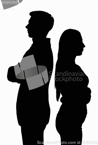 Image of A silhouetted contoured black white portrait of a young couple standing with their backs to each other