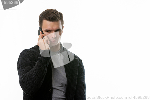 Image of Portrait of a sad young man talking on the phone