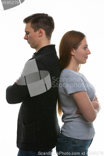 Image of A man and a woman got into a quarrel and stood with their backs to each other