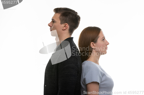 Image of Portrait of a man and a woman standing with their backs to each other