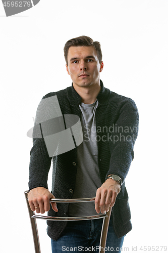 Image of Portrait of a somewhat sad young man on a white background