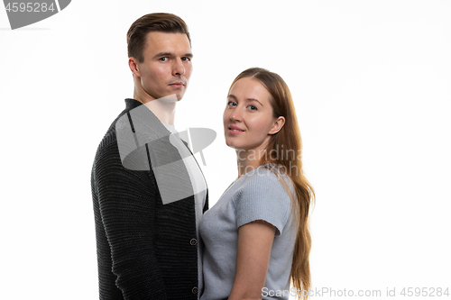 Image of Portrait of a young family, standing opposite each other and looked into the frame