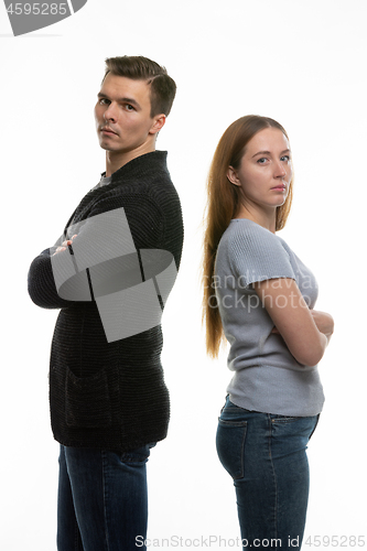 Image of The couple got into a fight and standing with their backs to each other in the frame