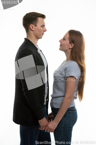 Image of The guy and the girl are standing in front of each other and have taken their hands