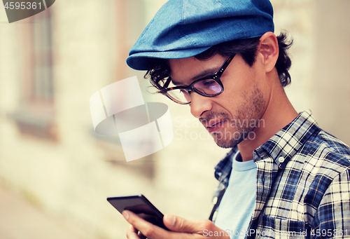 Image of close up of man texting message on smartphone