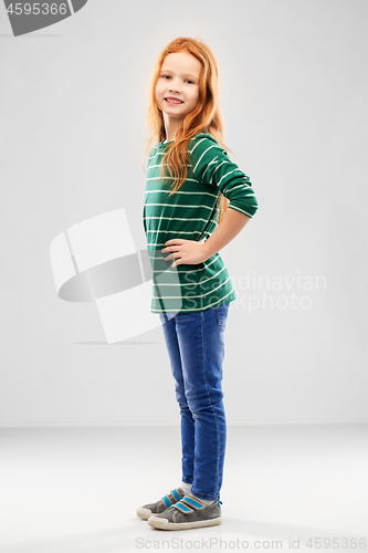 Image of smiling red haired girl posing in striped shirt