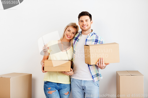 Image of happy couple with boxes moving to new home