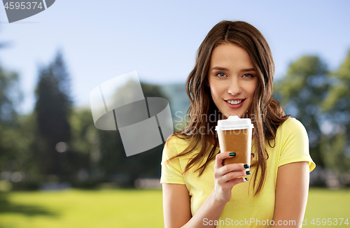 Image of woman or teenage girl drinks coffee at summer park